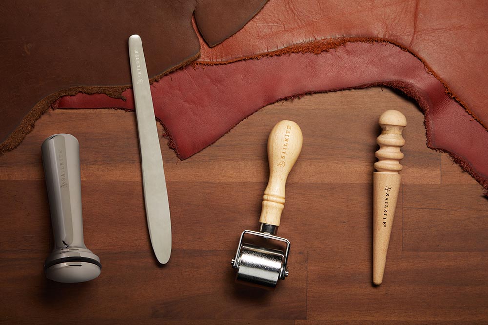 From left: a leather surface burnisher, folder/creaser tool, leather press roller and leather slicker.